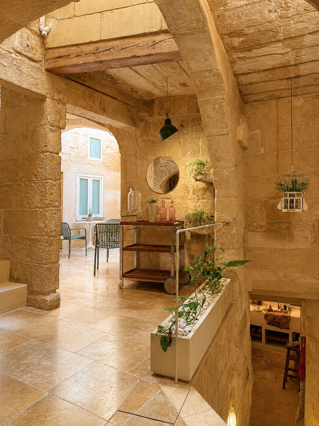Restored Maltese interior with arched window and stone walls