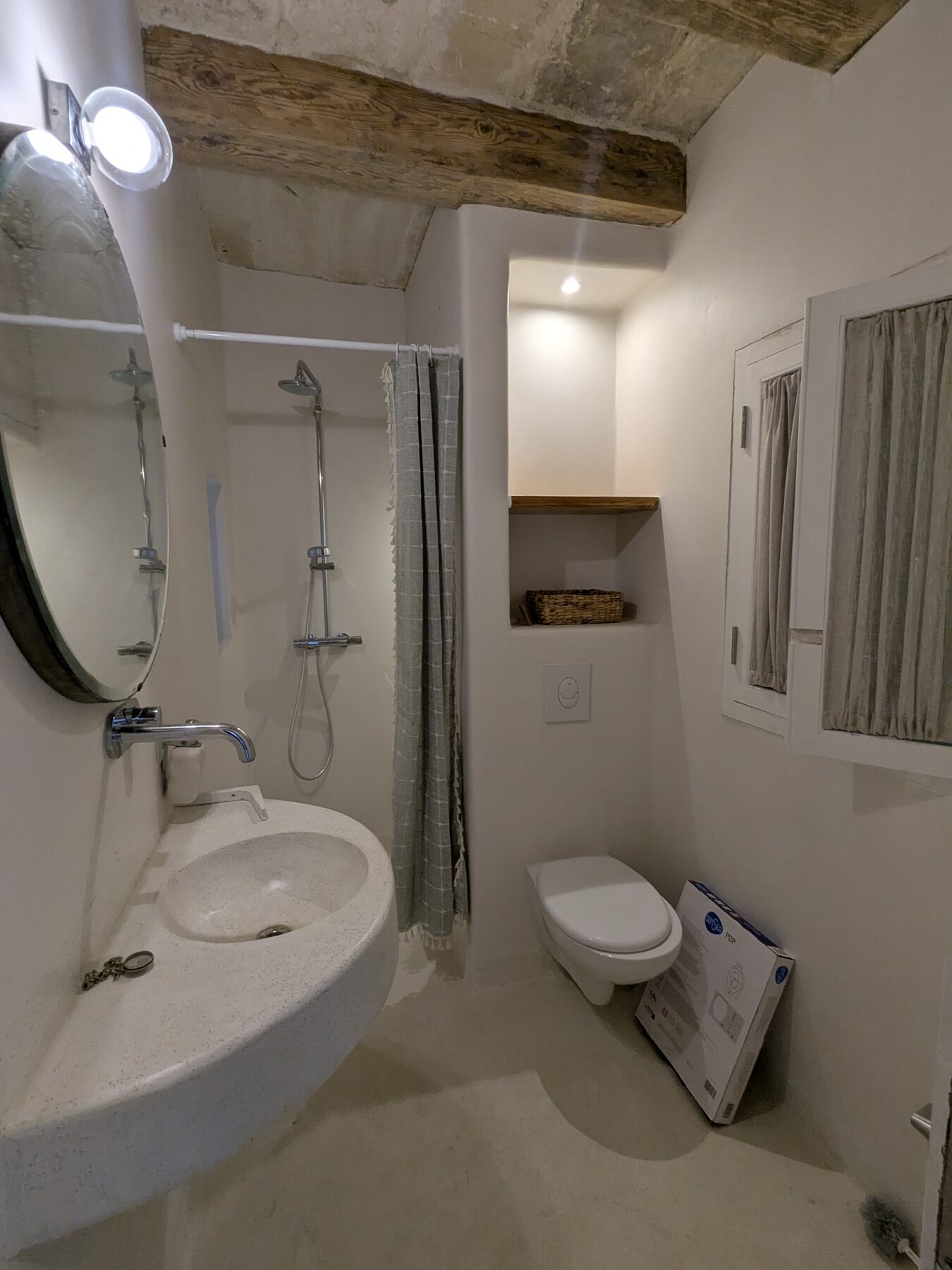 Bathroom with stone vessel sink and arched mirror