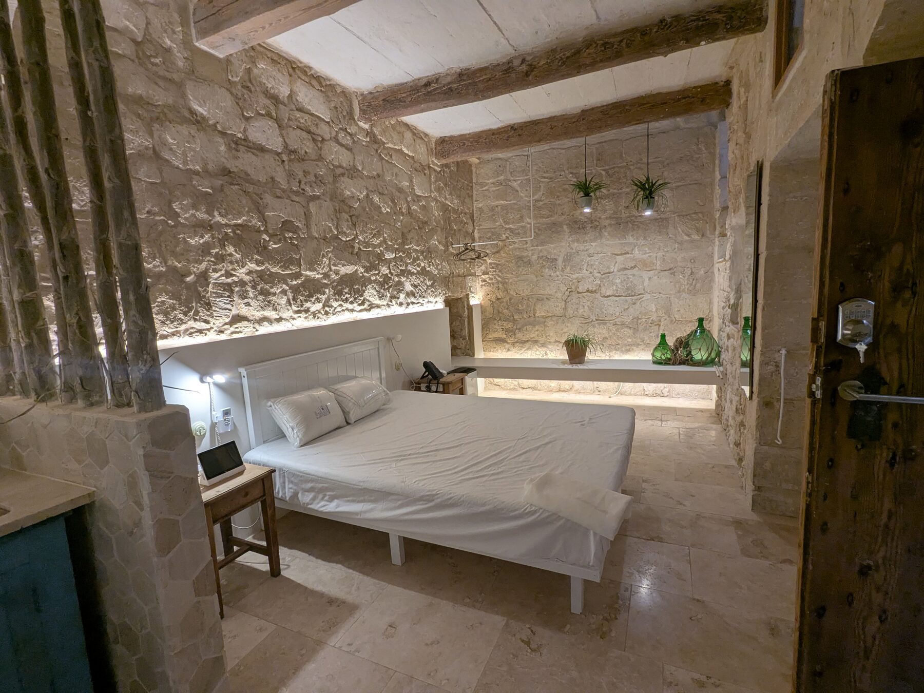 Restored Maltese interior with arched window and stone walls